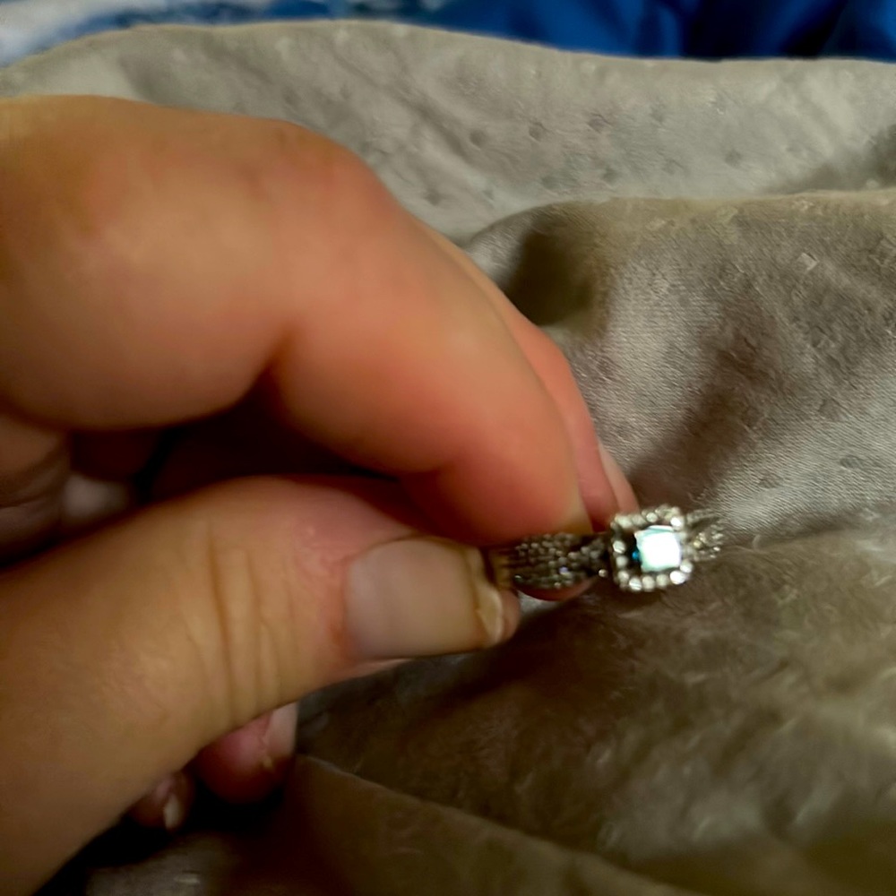 One carat Blue Diamond with diamonds on either side size 8. Can be sized